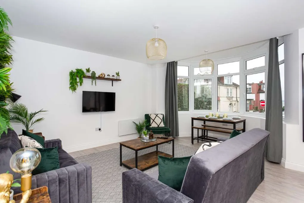 a living room filled with furniture and a flat screen tv