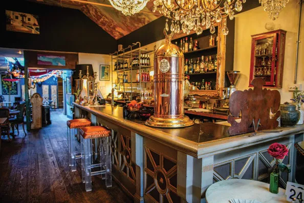a bar with a chandelier hanging from the ceiling