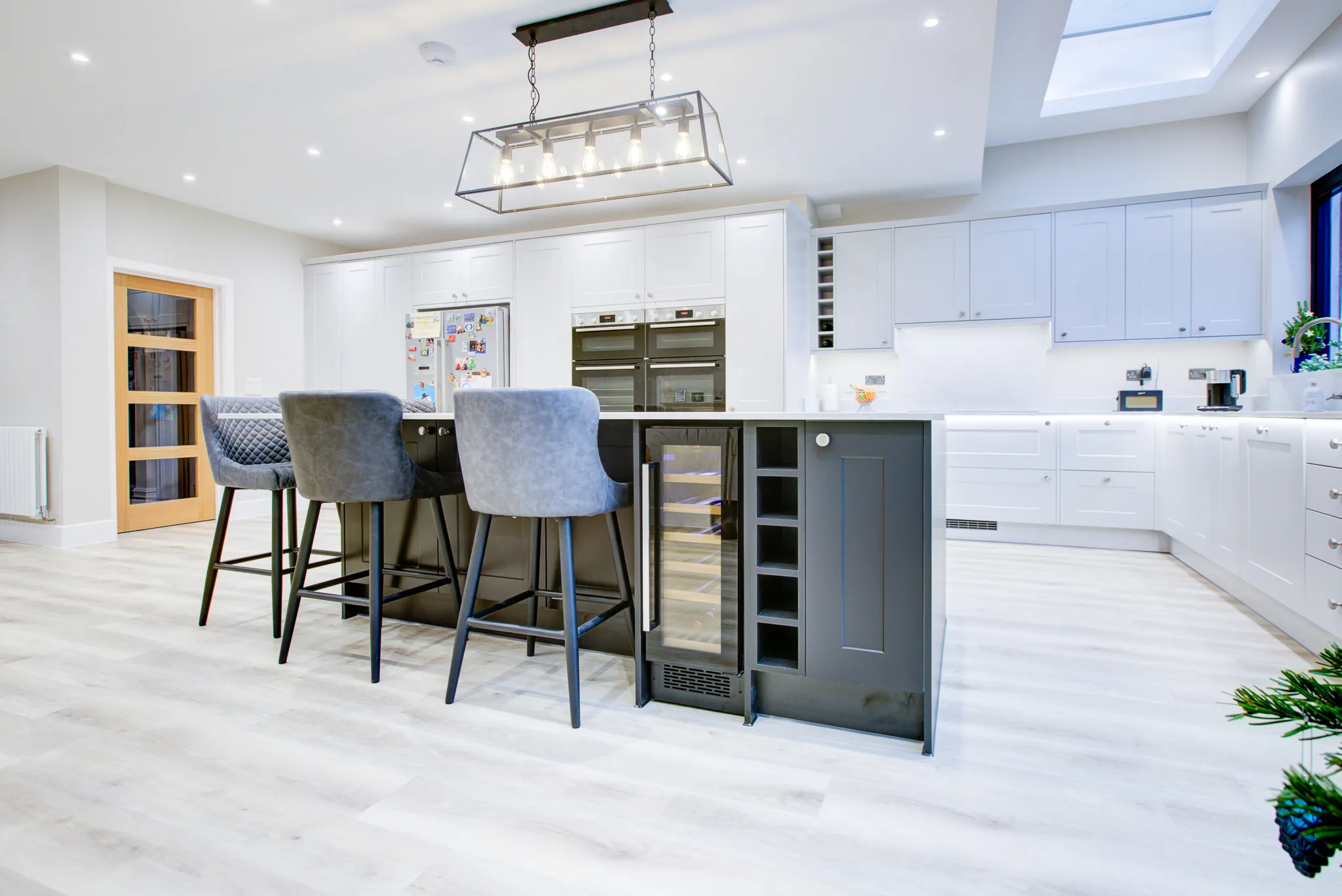 A kitchen with a center island and bar stools.
